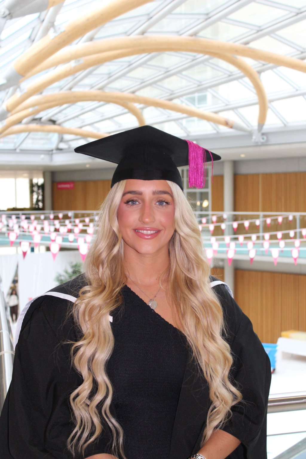 A female student graduating from Nottingham Business School in Digital Marketing.